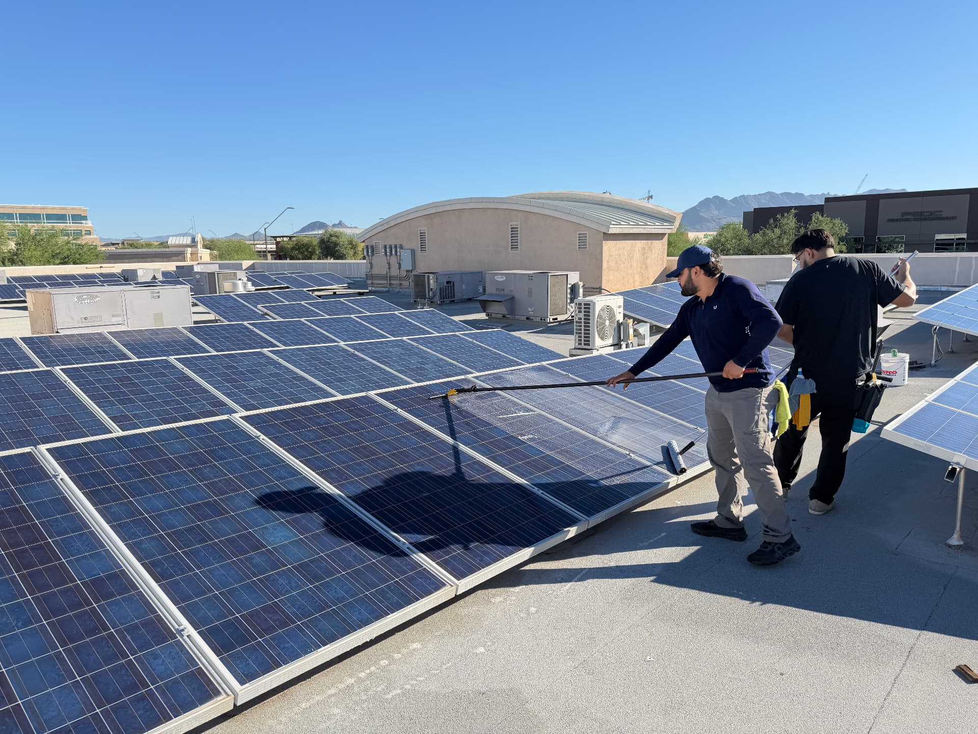 Cleaning rooftop solar panels on a Phoenix, Arizona commercial building