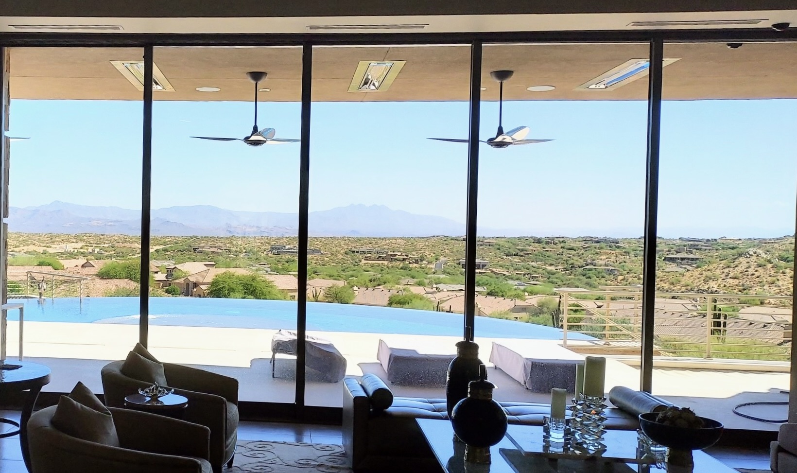 Luxury Scottsdale, Arizona living room with clear glass overlooking an infinity pool