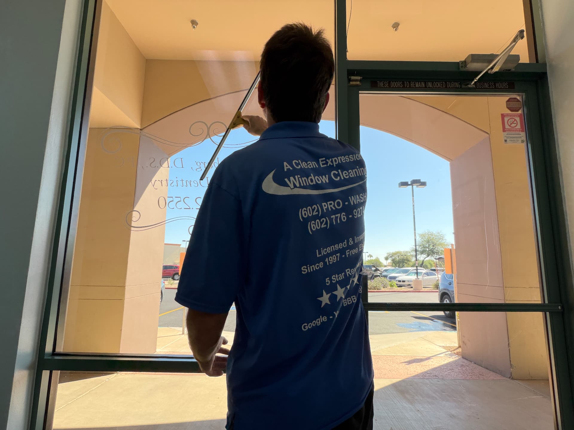 A A Clean Expression Window Cleaning crew member cleaning glass on a Phoenix-area property